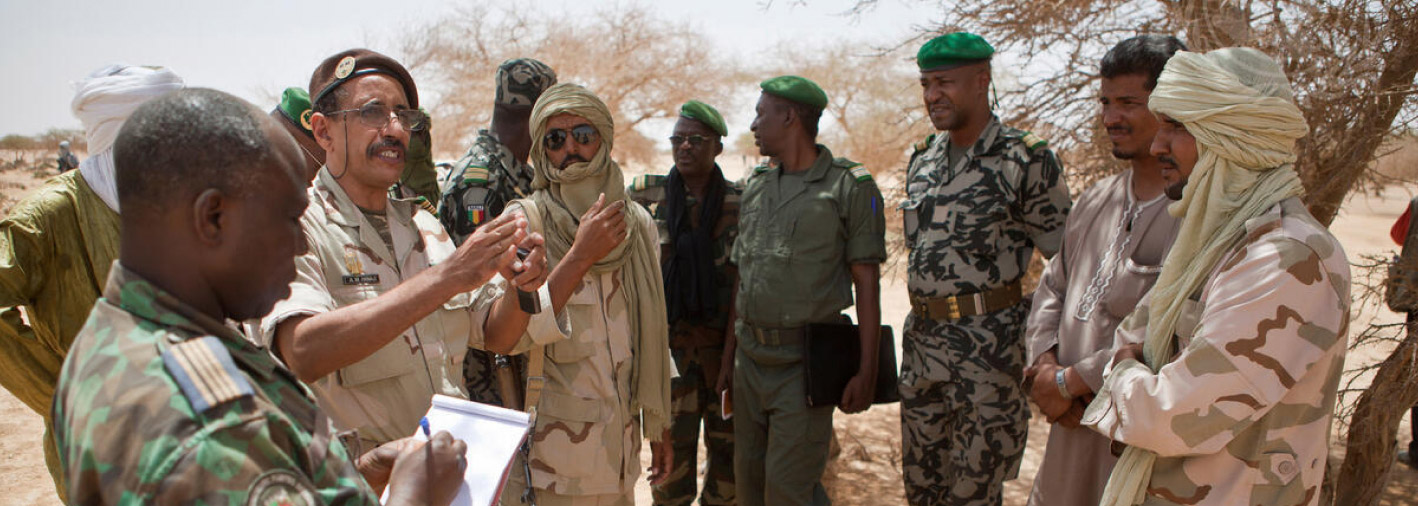 Image of people talking in the field