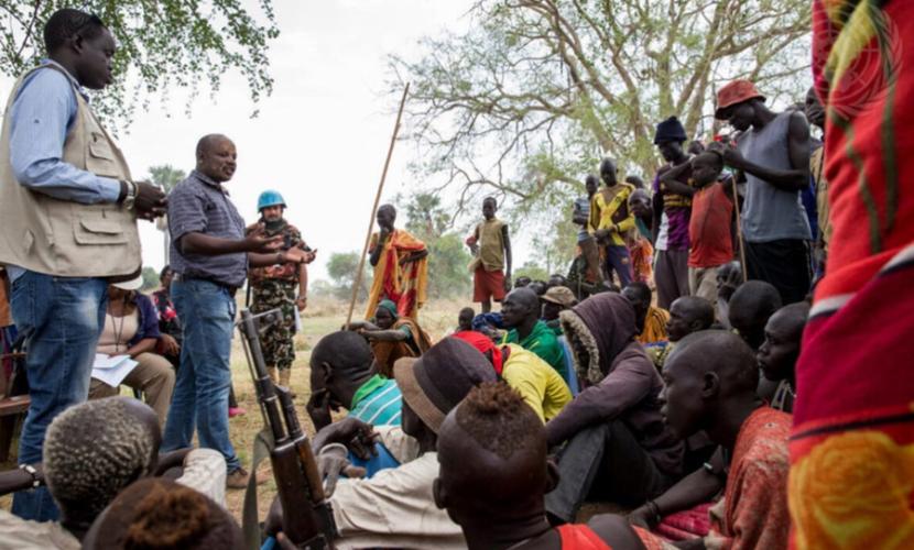 A man addresses a group of participants at a local community mediation